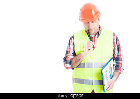 Costruttore di attrezzature di lavoro tenendo appunti con schemi e guardando pensieroso isolato su sfondo bianco con spazio di copia Foto Stock