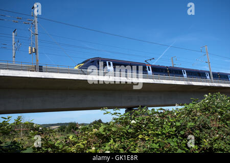 Giavellotto treno ad alta velocità che viaggiano verso la costa come si attraversa il fiume Medway nel Kent, Regno Unito Foto Stock