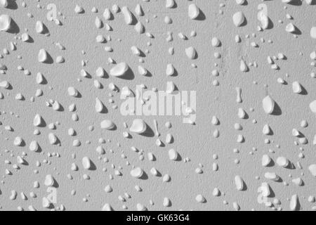 Muro Bianco spruzzato sulle con gocce Foto Stock