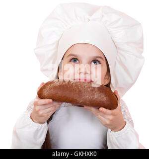 Bambina in cook hat guardando in alto, isolati su sfondo bianco Foto Stock