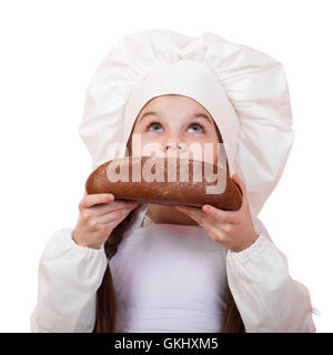 Bambina in cook hat guardando in alto, isolati su sfondo bianco Foto Stock