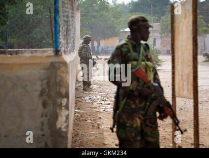 SOMALIA, Jawahar: in un handout fotografia scattata 11 Dicembre e rilasciato dall'African Union-United Nazioni Informazioni sul team di supporto 12 Dicembre, soldati ugandesi che serve con la missione dell Unione Africana in Somalia (AMISOM) stand di protezione su una strada della città di Jawahar nel Medio Scebeli regione a nord della capitale somala Mogadiscio. Somali Esercito Nazionale (SNA) forze supportato da AMISOM catturato la città di Jawahar, 90km a nord di Mogadiscio, in data 9 dicembre da Al Qaeda affiliate del gruppo estremista al Shabaab incontrando un po' di resistenza come essi sono entrati la strategica ed economicamente importan Foto Stock