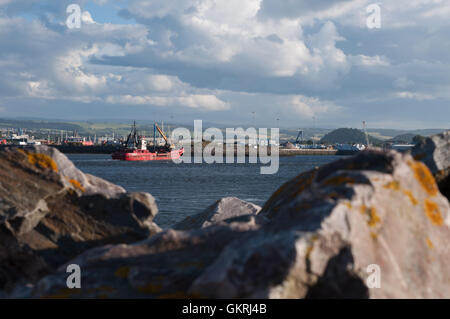 Un rosso barca si avvicina il fiume Ness in Inverness dal Moray Firth Foto Stock