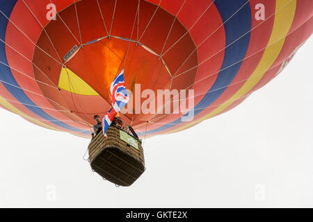 In mongolfiera ad aria calda passa sopra la testa con il suo bruciatore sul presso la trentottesima annuale di Bristol International Balloon Fiesta Foto Stock