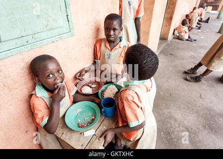 Un gruppo di ragazze pranzare durante una pausa dagli studi presso una scuola in Uganda Foto Stock