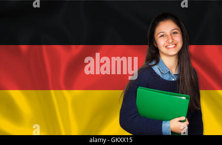 Teen studente sorridente sulla bandiera tedesca. Concetto di insegnamento e apprendimento delle lingue straniere. Foto Stock