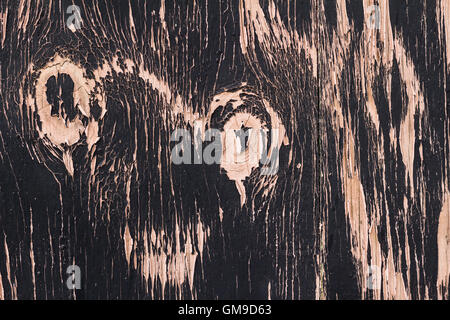 Foto di texture di sfondo con sfaldabile vecchia vernice nero su rosa legno verniciato Foto Stock