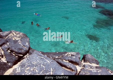 Vista aerea di nuotatori nelle acque cristalline di Waimea Bay Oahu, Hawaii Foto Stock