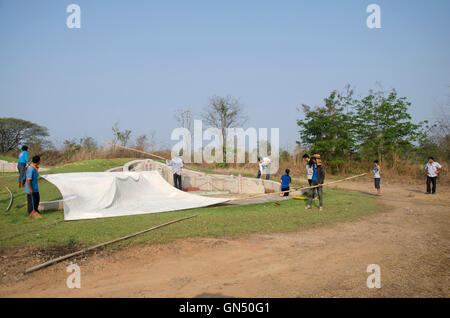 Lavoratore tailandese preparare una tenda per persone in preghiera nel cimitero di antenato adorando nel Qingming Festival nel cimitero Sritasala su Foto Stock