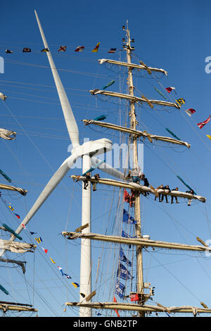 Blyth, Northumberland e di lavoro degli equipaggi aloft sul brigantino polacca "Fryderyk Chopin" contro un 128 metri di vento ad alta velocità turbina. Foto Stock