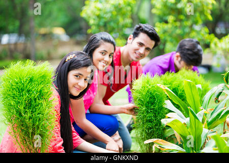 4 ragazzi e ragazze amici park la vita vegetale la piantagione di piante Foto Stock