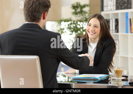 Handshaking imprenditori dopo la negoziazione o intervista in ufficio Foto Stock