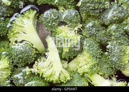 Broccoli verdi tagliati a fettine in acqua Foto Stock