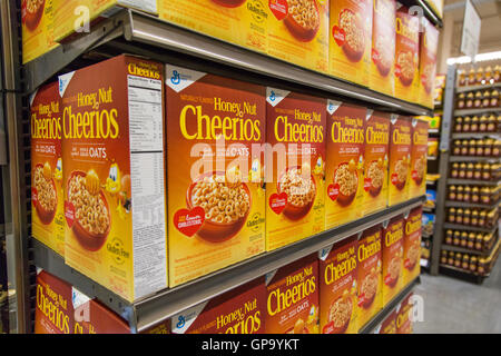 Scatole di General Mills il dado di miele cereali Cheerios sulla visualizzazione in corrispondenza di drogheria ripiani Foto Stock