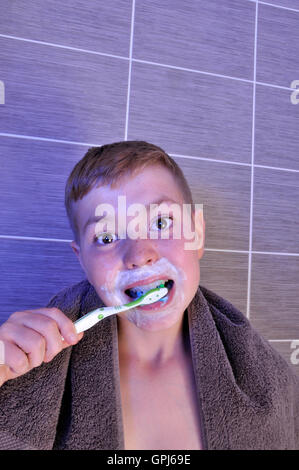 Ragazzo giovane spazzolatura dei denti Foto Stock