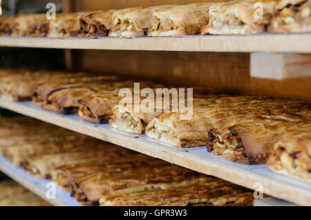 Cremagliere piena di tradizionale strudel in una panetteria Foto Stock