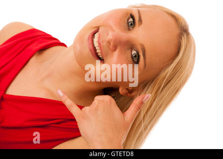 Donna bionda in maglietta rossa che designa qualcosa con il pollice in alto  Foto stock - Alamy