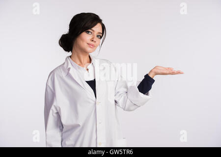 Rivolta verso la copia in bianco spazio donna medico infermiere su sfondo bianco Foto Stock