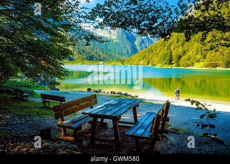 Panche di legno e un tavolo con una straordinaria vista sul lago e tw Foto Stock