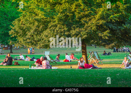 People Park estate, vista delle persone che si rilassano in una calda serata estiva a St James's Park, nel centro di Londra, Inghilterra, Regno Unito. Foto Stock