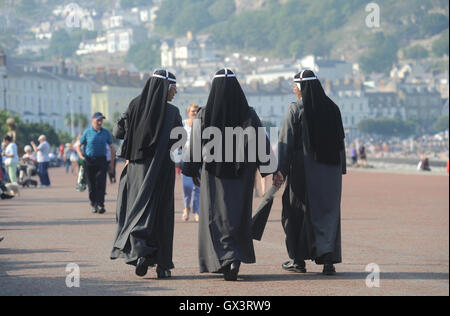 Le donne in abito religioso a piedi RE multi culturale GARA COMUNITARIA razzista stile burka di copertura del corpo bianco nero marrone religione REGNO UNITO Foto Stock