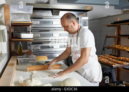 Baker lavora nel panificio Foto Stock