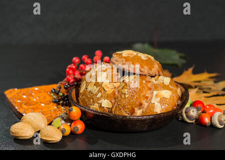 Tipico olandese piccante riempito i biscotti con mandorle in autunno colorato e lo sfondo scuro Foto Stock