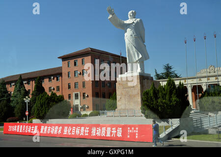 Una statua del compianto presidente Mao Zedong si erge di fronte YTO(Luoyang) motore Diesel Co., Ltd. in Luoyang, nella provincia di Henan, Cina. Foto Stock