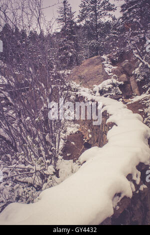 Muro di pietra sotto la neve Foto Stock