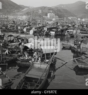 Anni '50, storico, una vista da questa epoca del villaggio galleggiante di Aberdeen, Hong Kong, sull'isola di Hong Kong, tradizionalmente un luogo di rifugio per i pescatori locali. Storicamente molti di loro vivevano sulle loro barche da pesca conosciute come giunchi e divennero le 'persone che vivono sull'acqua'. La gente delle barche di Hong Kong ha continuato a vivere nel villaggio galleggiante di Aberdeen attraverso gli anni '60 e '70. Foto Stock