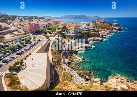 Vista bella Corsica Costa e case storiche in Calvi città vecchia con il turchese chiaro acque oceaniche, Corsica, Francia, Eur Foto Stock