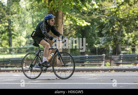 Un uomo anziano in bicicletta nel parco centrale. Foto Stock