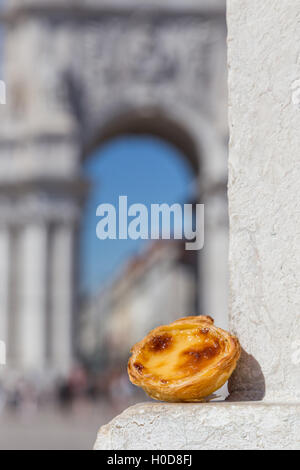 Tradizionale portoghese crostata di uovo pastoso dessert torta Pasteis de nata su sfondo attrazioni di Lisbona, Portogallo. Foto Stock