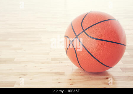 La pallacanestro palla sul pavimento in legno, con effetto di profondità di campo. Il rendering 3D Foto Stock