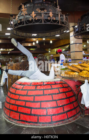 La cottura della tradizionale georgiano armeno / il pane nel forno chiamato tonir in Aparan, Armenia Foto Stock