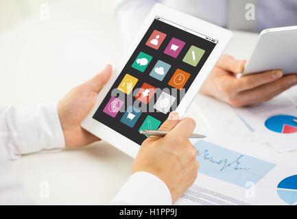Stretta di mano con le icone di menu sul tablet pc Foto Stock