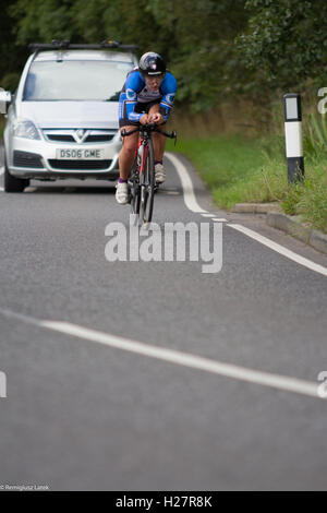 Accelerando professionalmente vestito ciclisti sull'asfalto durante il concorso in Scozia Foto Stock