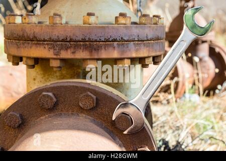 Sfavillante nuova chiave su un arrugginito bollt Foto Stock