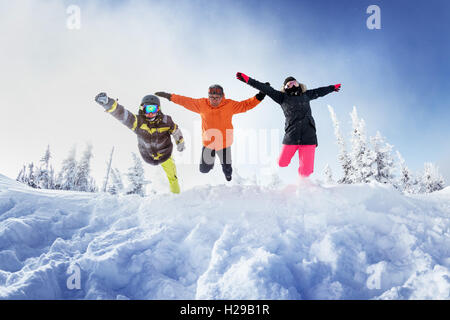 Gli appassionati di snowboard in posa sul cielo blu sullo sfondo di montagne Foto Stock