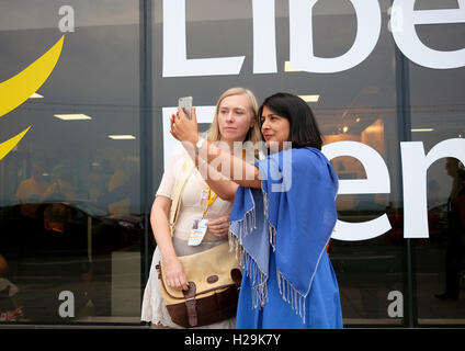 I delegati dei democratici e liberali partito in Brighton 2016 prendendo un selfie davanti al logo di partito. Foto Stock