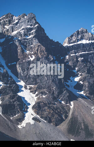 Montagna ruvida con scogliere e neve nel cielo blu Foto Stock