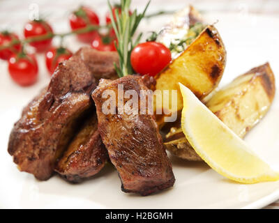 Costolette alla griglia, patate fritte e verdure Foto Stock