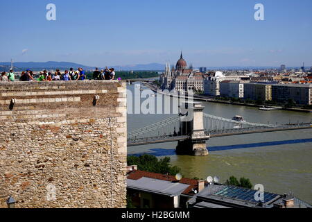 Il palazzo del Parlamento, visto dal Palazzo Reale sulla Collina del Castello, lungo il Danubio, il Ponte della Catena attraverso il fiume, Budapest, Ungheria Foto Stock