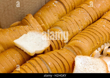 Pane bianco petite o sandwich collocato nella casella carta. closeup. Un mucchio di mini toast Foto Stock