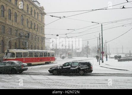 Inverno a Praga - il traffico e i pedoni in inverno Neve a Praga, Repubblica Ceca. La fotografia è stata scattata vicino al Ponte Manesuv. Foto Stock