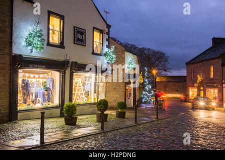 Colorate luci di Natale illumina il buio di un inverno di sera - Grassington Village, Yorkshire Dales National Park, Inghilterra. Foto Stock