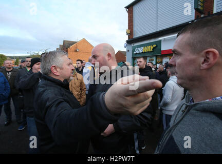 Damien "Dee" Fennell (centro), un portavoce per la maggiore Ardoyne Residents' collettivo (García), sostiene con sacerdote locale Padre Gary Donegan (sinistra) dopo un ordine arancione parade passati lungo il Crumlin Road adiacente al partito nazionalista Ardoyne distretto a Belfast nord. Foto Stock