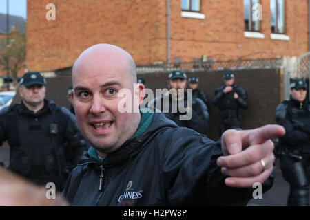 Damien 'EE' Fennell, un portavoce per la maggiore Ardoyne Residents' collettivo (García), parla ai media dopo un ordine arancione parade passati lungo il Crumlin Road adiacente al partito nazionalista Ardoyne distretto a Belfast nord. Foto Stock