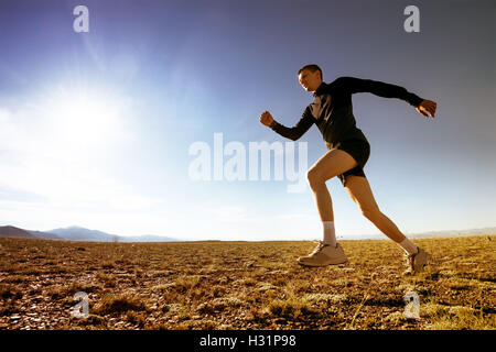 Sportivo in esecuzione sul cielo concetto Natura Foto Stock