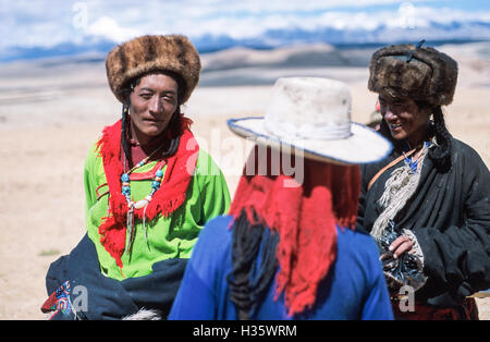 Tibetani su un pellegrinaggio intorno al monte Kailash. Il Sacro Monte è in alto a sinistra della foto. Foto Stock